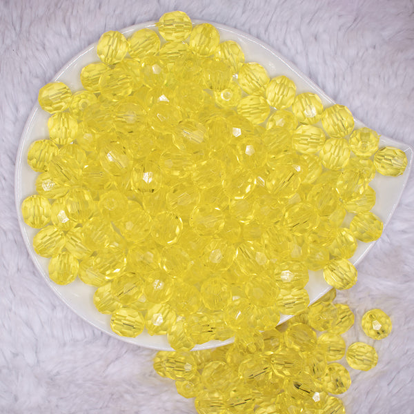 top view of a pile of 12mm Yellow Transparent Faceted Shaped Bubblegum Beads