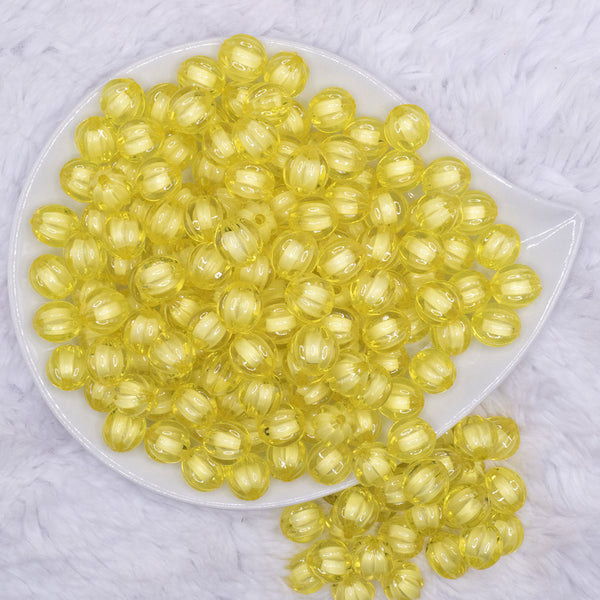 top view of a pile of 12mm Yellow Transparent Pumpkin Shaped Bubblegum Beads