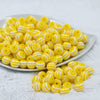 Front view of a pile of 12mm Yellow with White Stripes Resin Chunky Bubblegum Beads