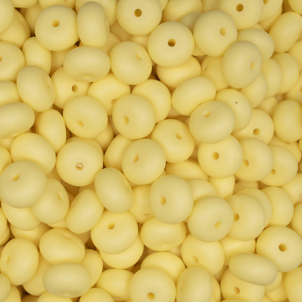 top view of a pile of 14mm Cream Yellow Abacus Silicone Bead