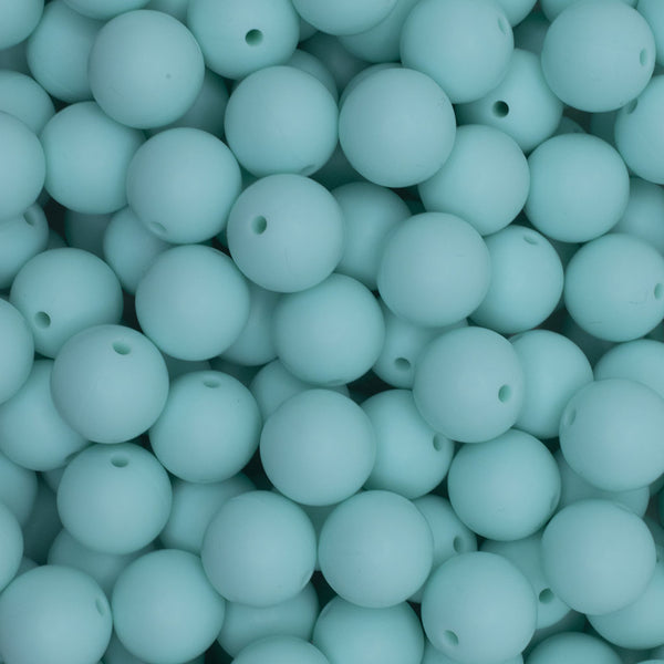close up view of a pile of 15mm Aqua Green Round Silicone Bead