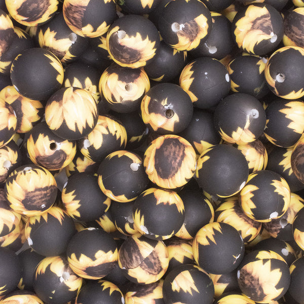 close up view of a pile of 15mm Black and Yellow Sunflower Print Round Silicone Bead