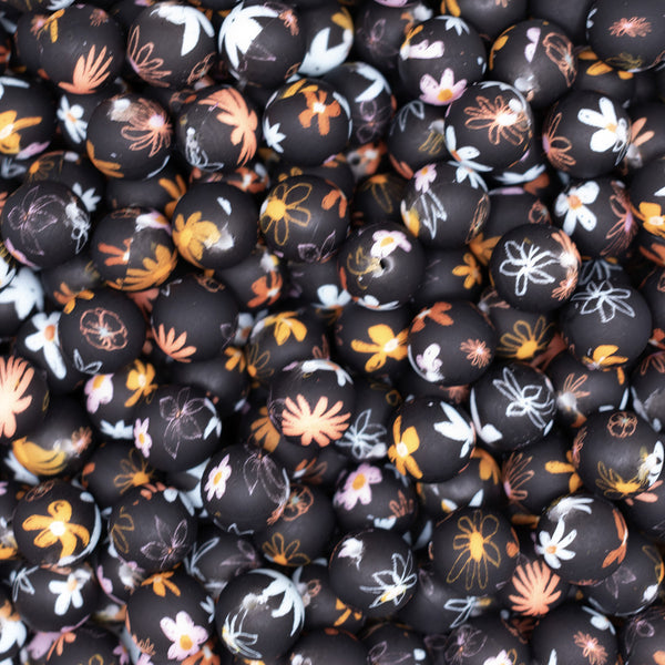top view of a pile of 15mm Floral flower print on Black Round Silicone Bead