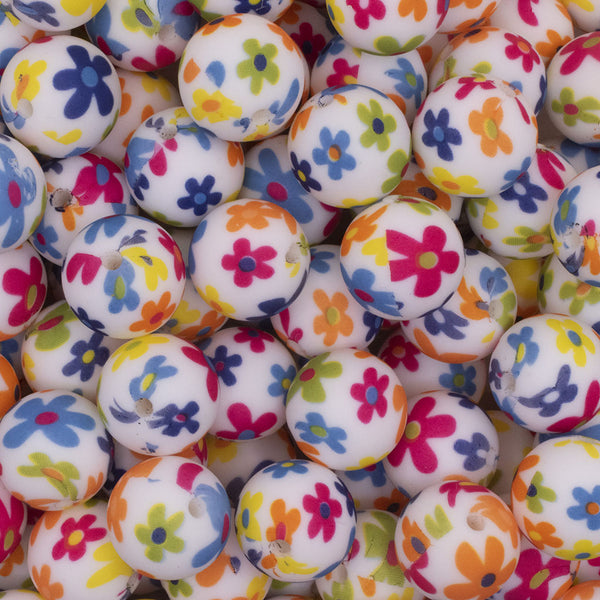 Close up view of a pile of 15mm Bright Flowers Print Round Silicone Bead