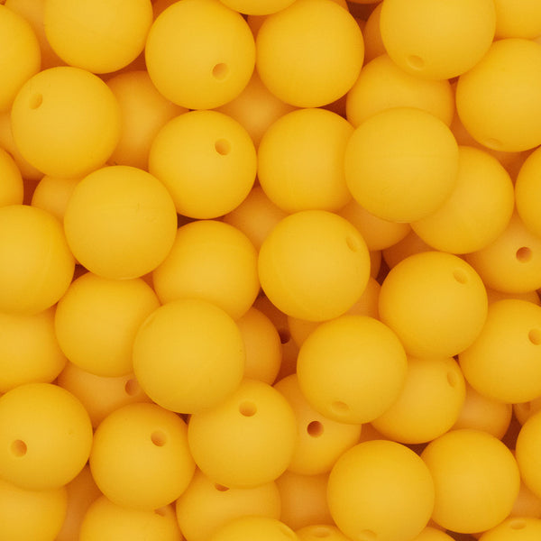 close up view of a pile of 15mm Bright Yellow Round Silicone Bead