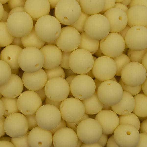 close up view of a pile of 15mm Cream Yellow Round Silicone Bead