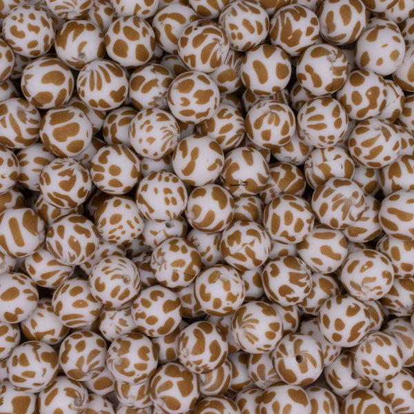 close up view of a pile of 15mm Gold Cow Print Round Silicone Bead