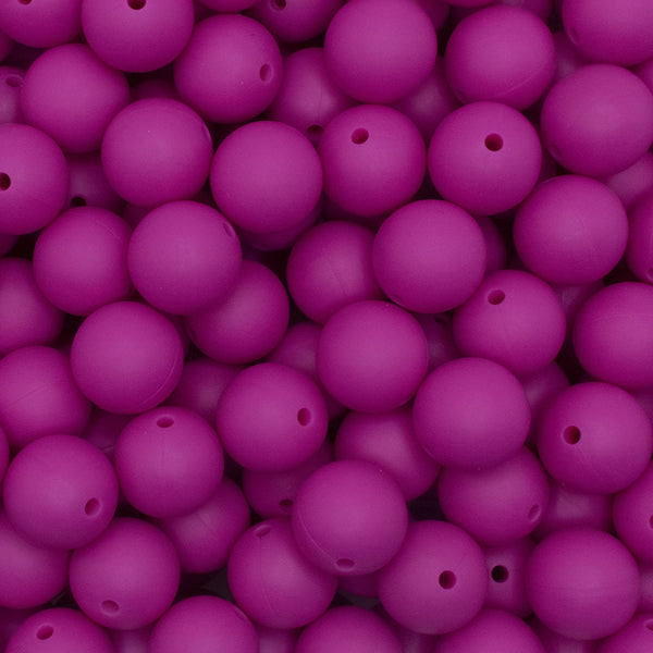 close up view of a pile of 15mm Hot Pink Round Silicone Bead