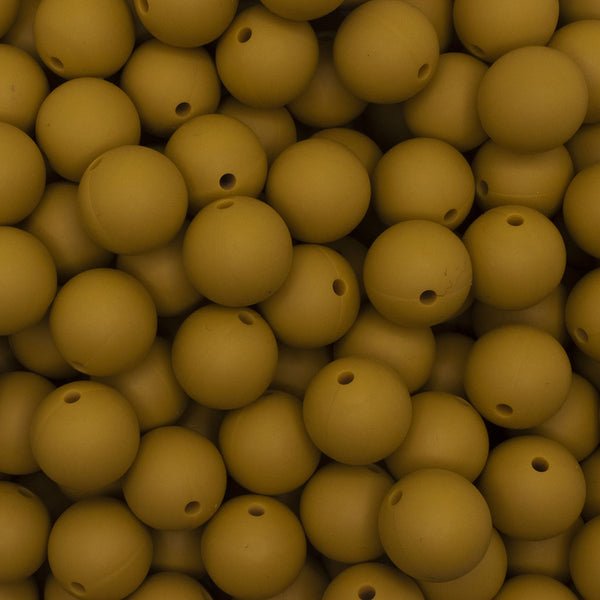 close up view of a pile of 15mm Mustard Yellow Round Silicone Bead
