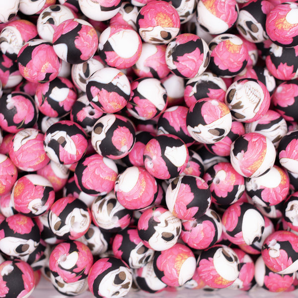 top view of a pile of 15mm Pink Flower with Skull print Silicone Bead