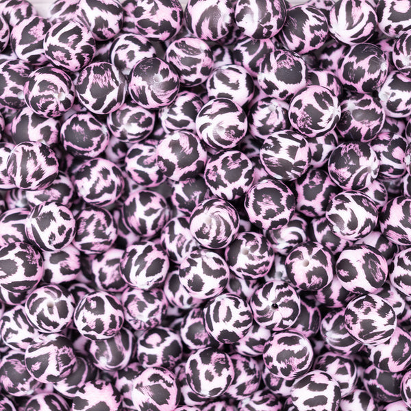 Close up view of a pile of 15mm pink leopard print silicone round bead