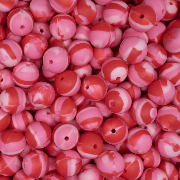 top view of a pile of 15mm Red and Pink Swirled Print Silicone Bead