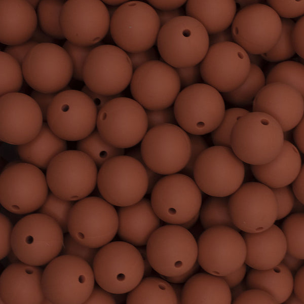 close up view of a pile of 15mm Rust Brown Round Silicone Bead