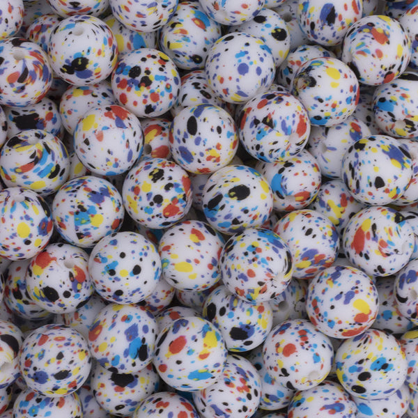 Close up view of a pile of 15mm Rainbow Splatter Print Round Silicone Bead