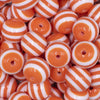 Close up view of a pile of 16mm Orange with White Stripe Bubblegum Beads