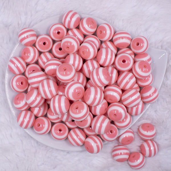 Top view of a pile of 16mm Salmon Pink with White Stripe Bubblegum Beads
