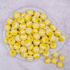 Top view of a pile of 16mm Yellow with White Stripe Bubblegum Beads
