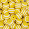 Close up view of a pile of 16mm Yellow with White Stripe Bubblegum Beads