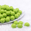 Front view of a pile of 16mm Apple Green Solid Acrylic Bubblegum Jewelry Beads