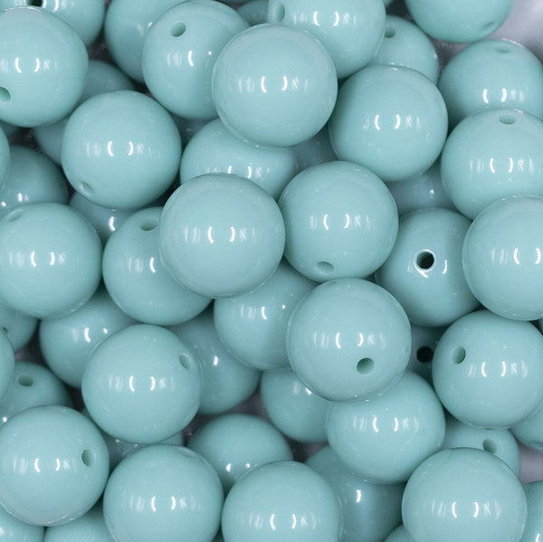 Close up view of a pile of 16mm Aqua Blue Solid Acrylic Bubblegum Jewelry Beads