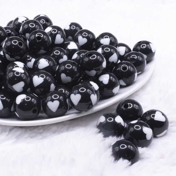 front view of a pile of 16mm Black with White Hearts Bubblegum Beads