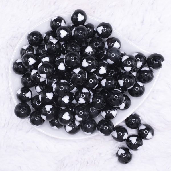 top view of a pile of 16mm Black with White Hearts Bubblegum Beads
