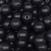 Close up view of a pile of 16mm Black Matte Pearl Acrylic Bubblegum Jewelry Beads
