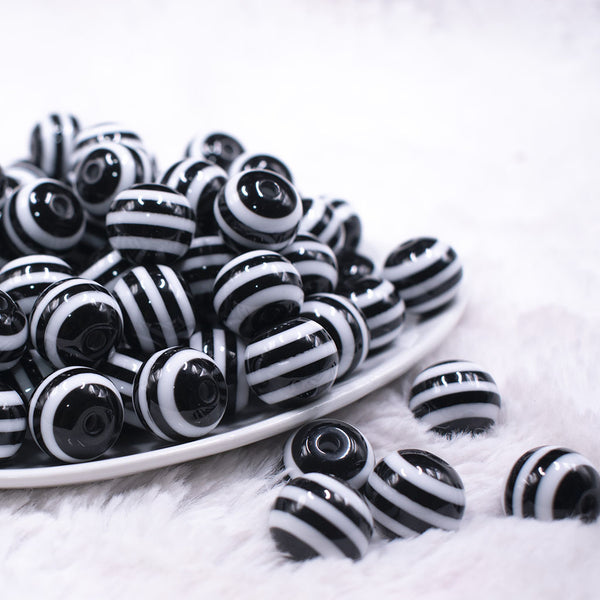 Front view of a pile of 16mm Black with White Stripe Bubblegum Beads
