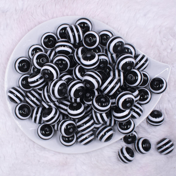 Top view of a pile of 16mm Black with White Stripe Bubblegum Beads
