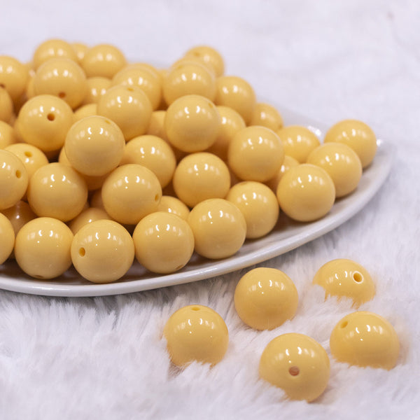 Front view of a pile of 16mm Blonde Yellow Solid Acrylic Bubblegum Jewelry Beads