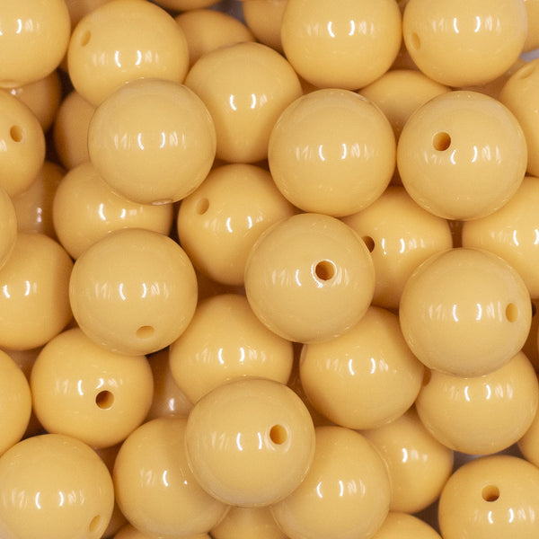 Close up view of a pile of 16mm Blonde Yellow Solid Acrylic Bubblegum Jewelry BeadsFront view of a pile of 16mm Blonde Yellow Solid Acrylic Bubblegum Jewelry Beads