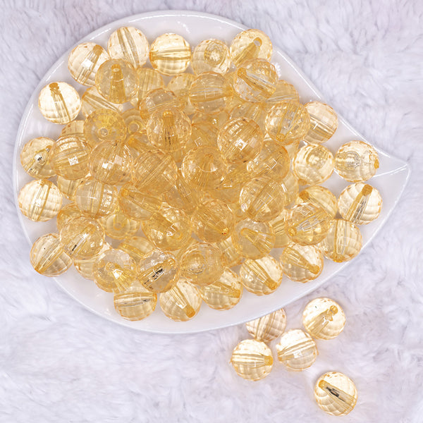 top view of a pile of 16mm Blonde Yellow Transparent Faceted Shaped Bubblegum Beads