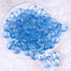 top view of a pile of 16mm Blue Transparent Faceted Shaped Bubblegum Beads