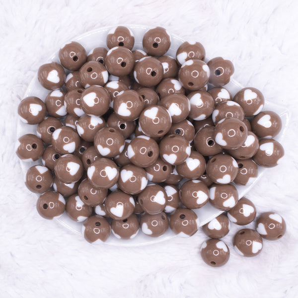 top view of a pile of 16mm Brown with White Hearts Bubblegum Beads