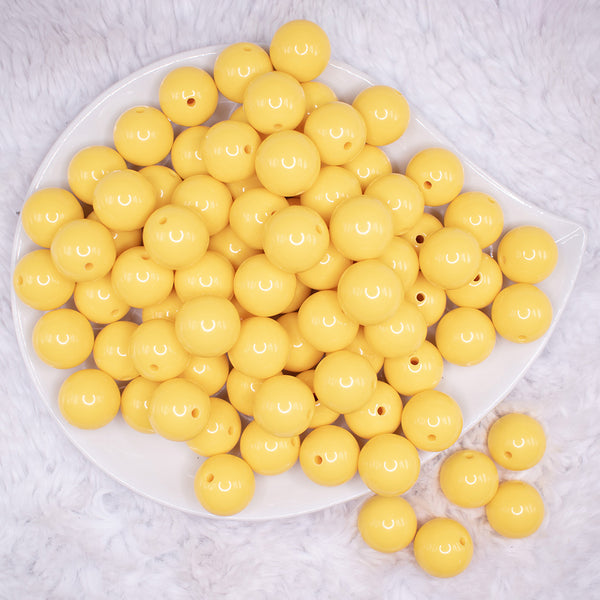 top view of a pile of 16mm Butter Yellow Solid Bubblegum Beads