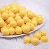 front view of a pile of 16mm Butter Yellow Solid Bubblegum Beads