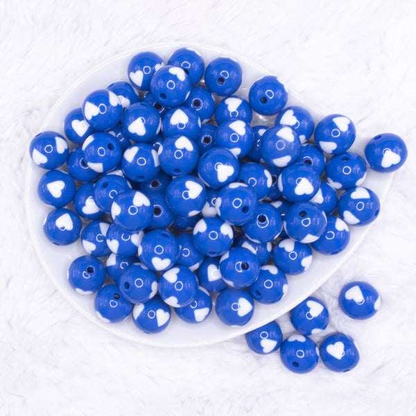 top view of a pile of 16mm Cobalt Blue with White Hearts Bubblegum Beads