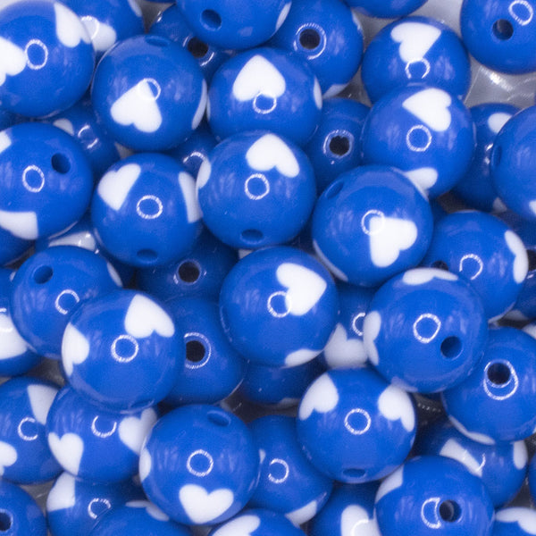close up view of a pile of 16mm Cobalt Blue with White Hearts Bubblegum Beads