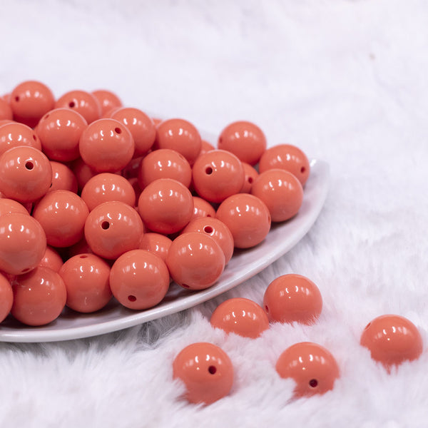 Front view of a pile of 16mm Coral Orange Solid Acrylic Bubblegum Jewelry Beads