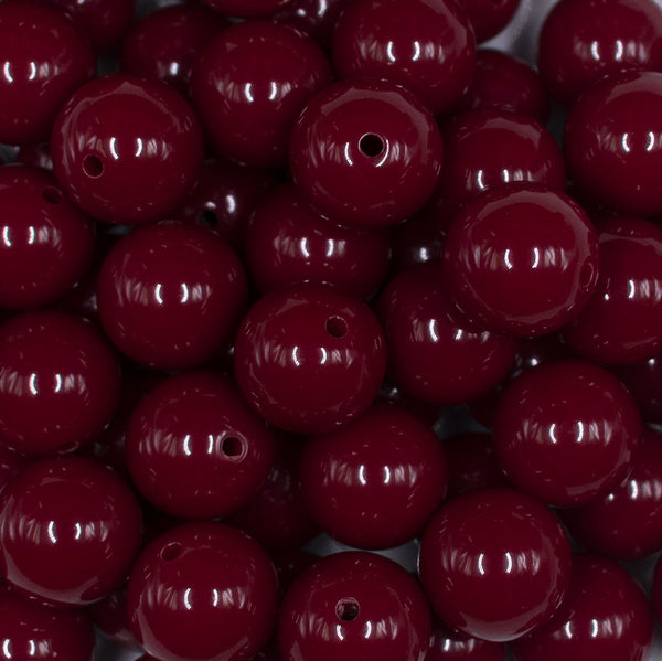 Close up view of a pile of 16mm Cranberry Red Solid Acrylic Bubblegum Jewelry Beads