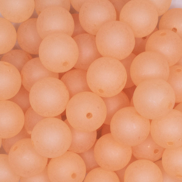 close up view of a pile of 16mm Light Orange Frosted Bubblegum Beads