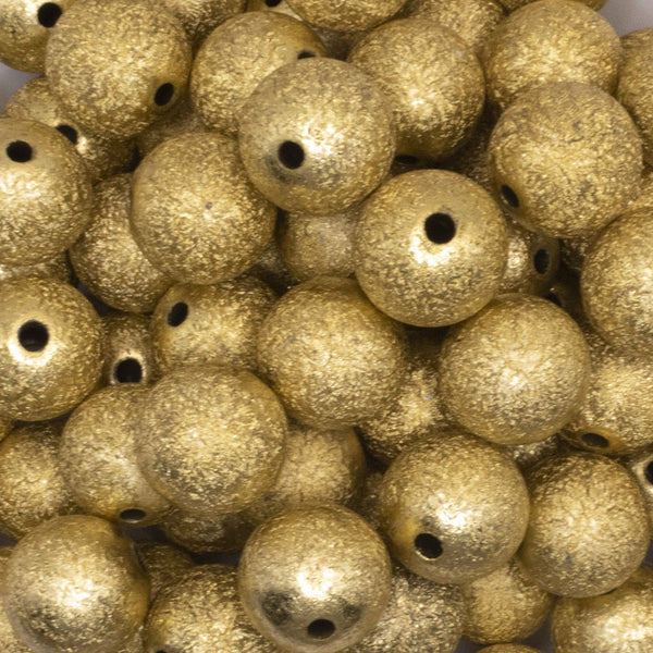 close up view of a pile of 16mm Gold Stardust Acrylic Bubblegum Beads