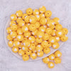 top view of a pile of 16mm Goldenrod Yellow with White Hearts Bubblegum Beads