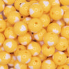 close up view of a pile of 16mm Goldenrod Yellow with White Hearts Bubblegum Beads