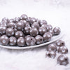 front view of a pile of 16mm Gray with White Polka Dots Bubblegum Beads