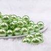 Front view of a pile of 16mm Grass Green Faux Pearl Acrylic Bubblegum Jewelry Beads