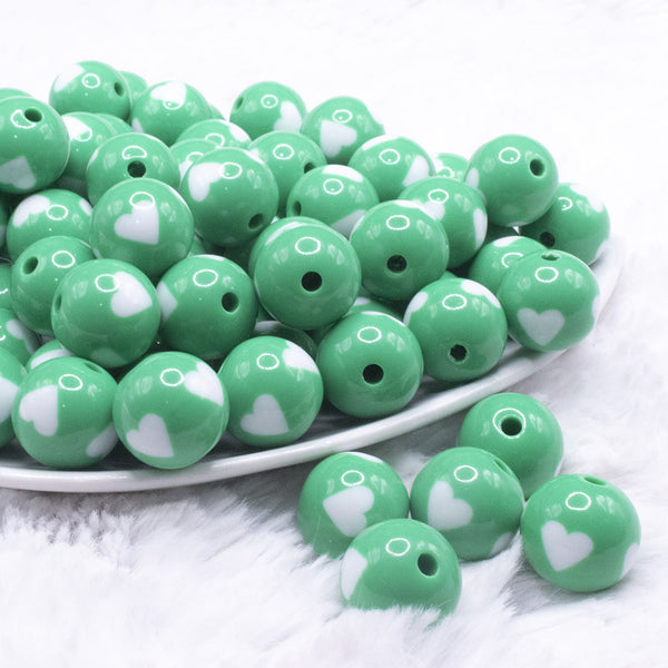 front view of a pile of 16mm Green with White Hearts Bubblegum Beads