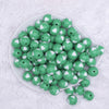 top view of a pile of 16mm Green with White Hearts Bubblegum Beads