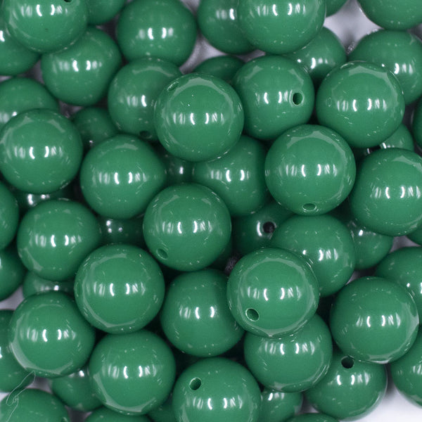 Close up view of a pile of 16mm Green Solid Acrylic Bubblegum Jewelry Beads