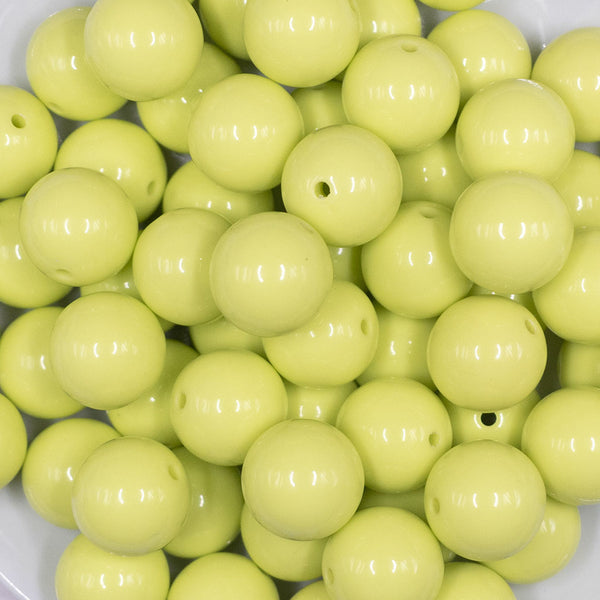 Close up view of a pile of 16mm Key Lime Green Solid Acrylic Bubblegum Jewelry Beads